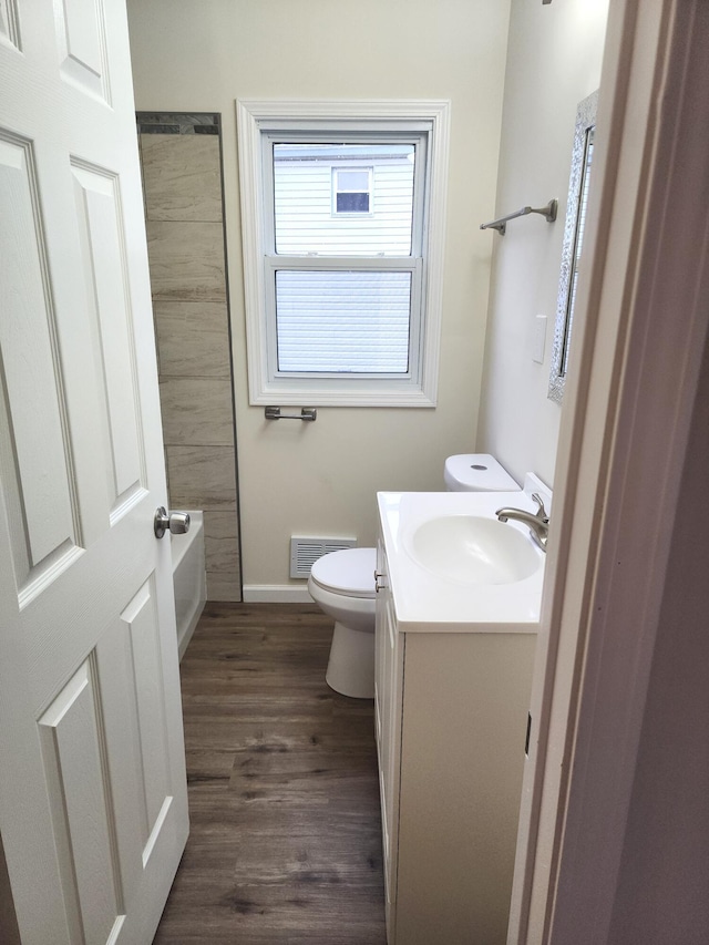 bathroom featuring vanity, hardwood / wood-style floors, and toilet