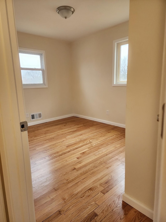 empty room with light wood-type flooring