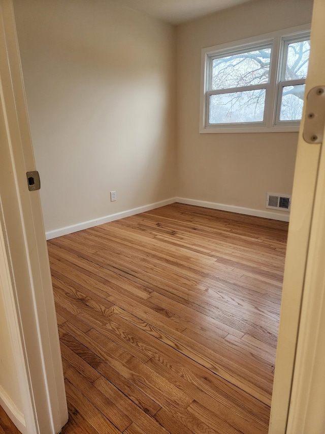 unfurnished room with light wood-type flooring