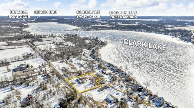 snowy aerial view featuring a water view