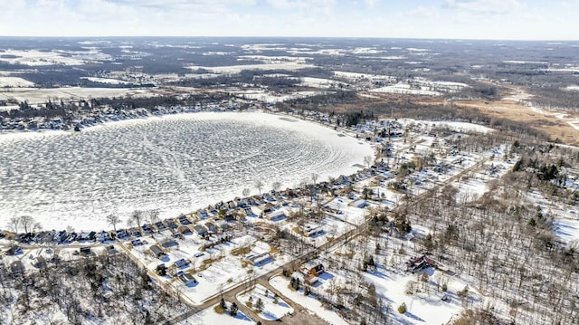 snowy aerial view featuring a water view