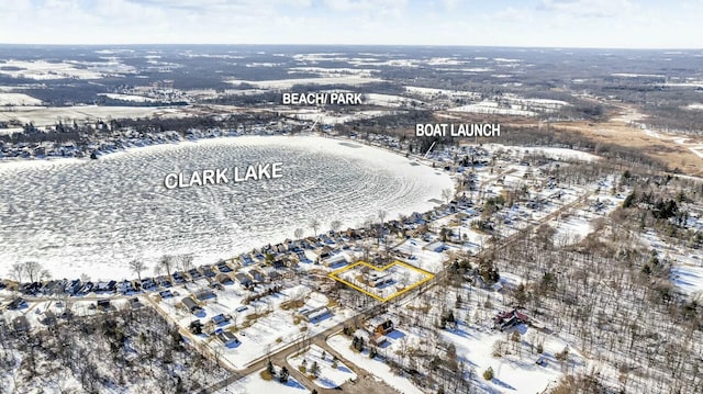 snowy aerial view featuring a water view