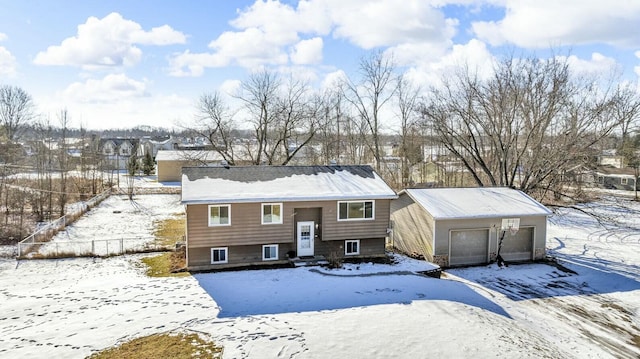 split foyer home featuring a garage and an outbuilding