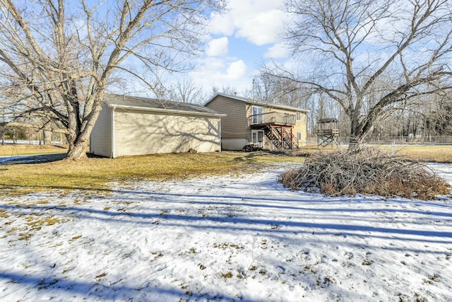 snow covered property with a wooden deck