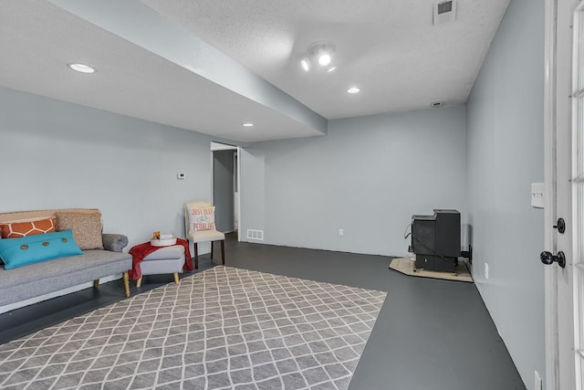 living area featuring a textured ceiling