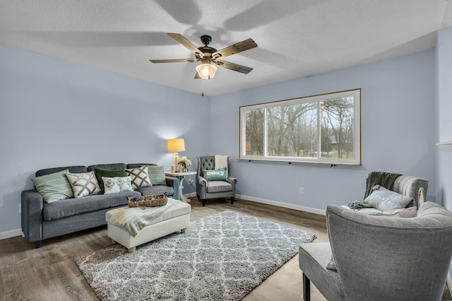 living room with wood-type flooring and ceiling fan