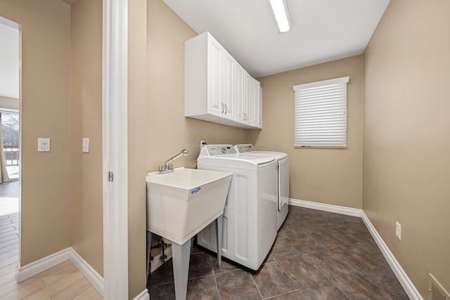 laundry room with cabinets and washing machine and clothes dryer