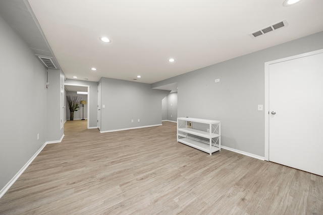 empty room with light hardwood / wood-style flooring