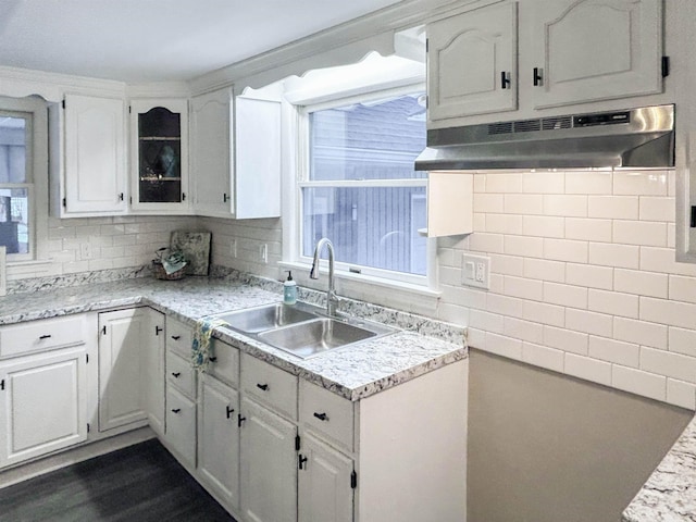 kitchen with tasteful backsplash, sink, a wealth of natural light, and white cabinets