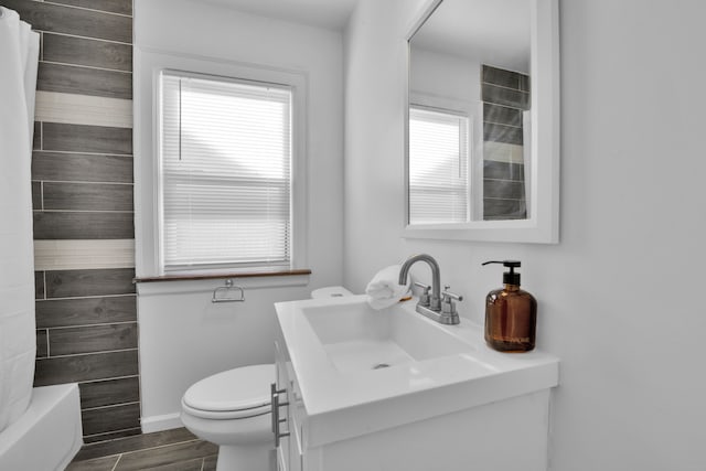 full bathroom with vanity, toilet, and shower / bath combo with shower curtain