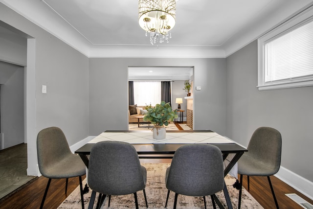 dining room with a chandelier and light wood-type flooring