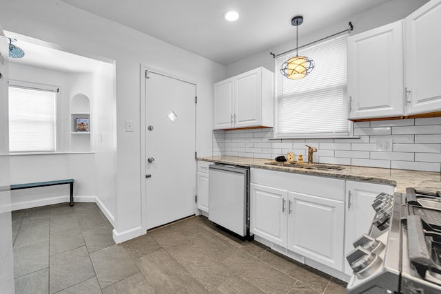 kitchen with dishwashing machine, sink, decorative light fixtures, and white cabinets