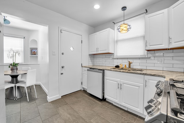 kitchen with hanging light fixtures, dishwasher, sink, and white cabinets