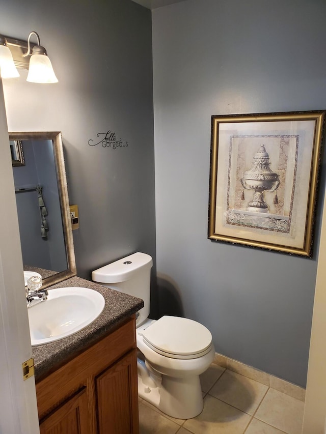 bathroom with tile patterned flooring, vanity, and toilet