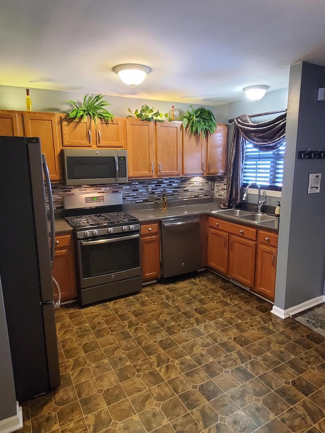 kitchen featuring appliances with stainless steel finishes, sink, and backsplash