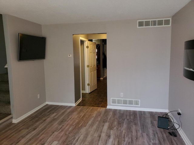 spare room featuring dark hardwood / wood-style flooring