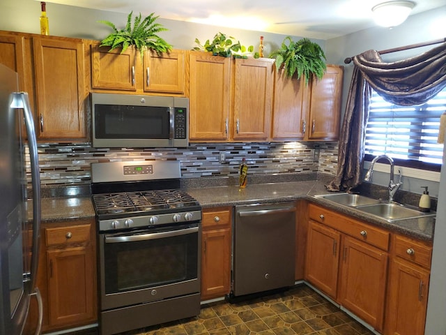 kitchen featuring tasteful backsplash, appliances with stainless steel finishes, and sink