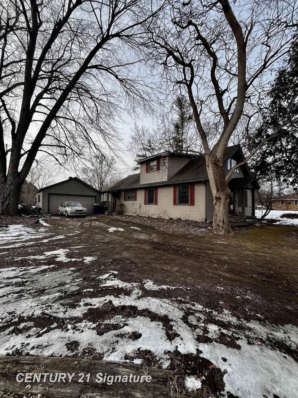 snow covered property featuring a garage