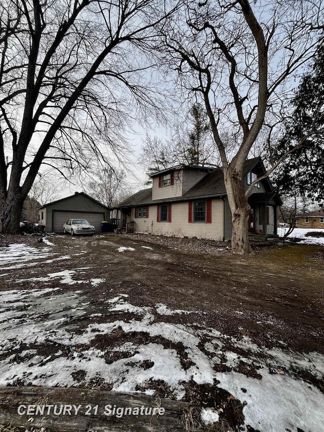 snow covered property featuring a garage