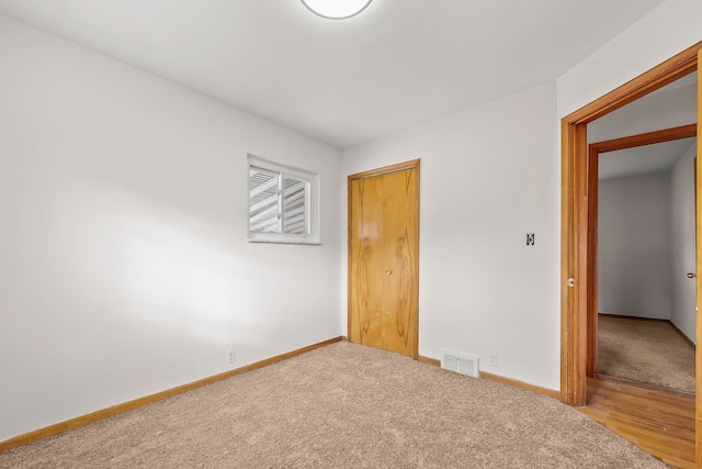 unfurnished bedroom featuring visible vents, baseboards, and carpet flooring