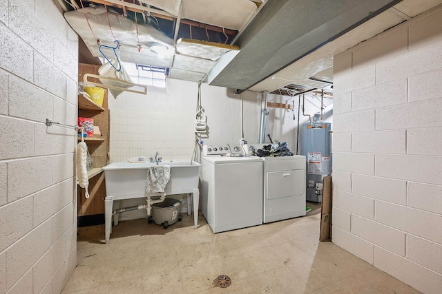 laundry room with a sink, washer and clothes dryer, water heater, and laundry area