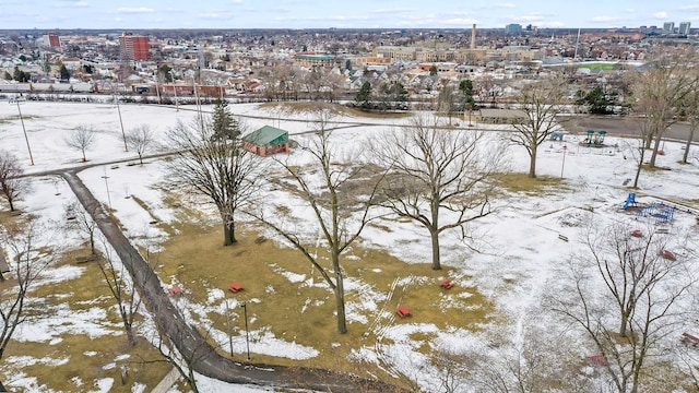 snowy aerial view with a city view