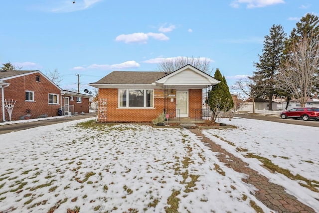 bungalow-style home with brick siding