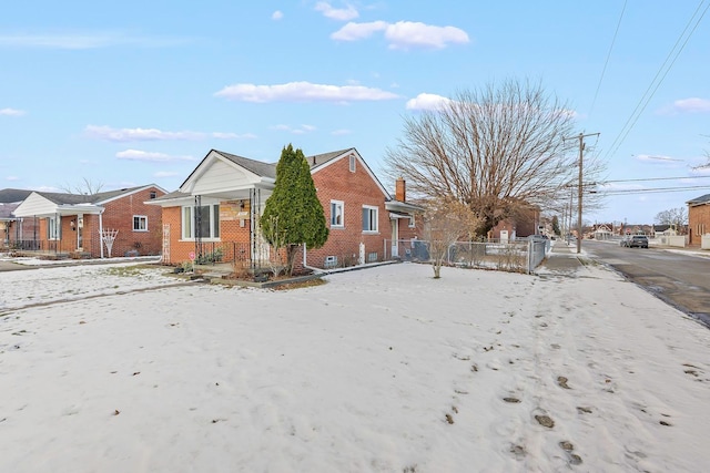 view of home's exterior featuring fence and brick siding