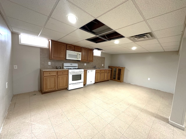 kitchen with visible vents, light floors, light countertops, decorative backsplash, and white appliances