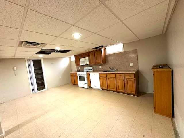 kitchen featuring visible vents, light floors, white appliances, and light countertops