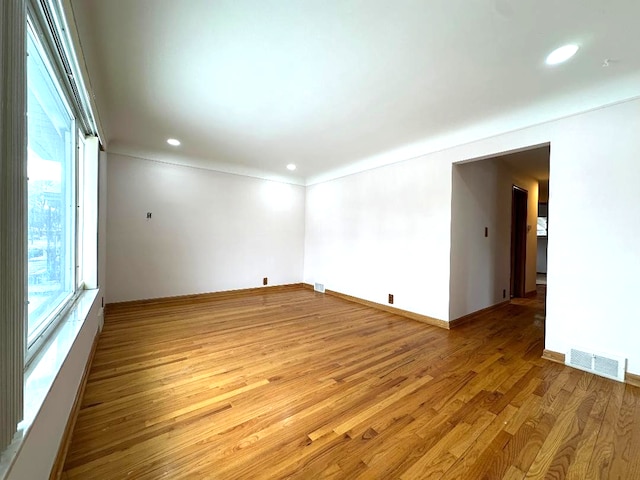 spare room featuring recessed lighting, visible vents, light wood-style flooring, and baseboards