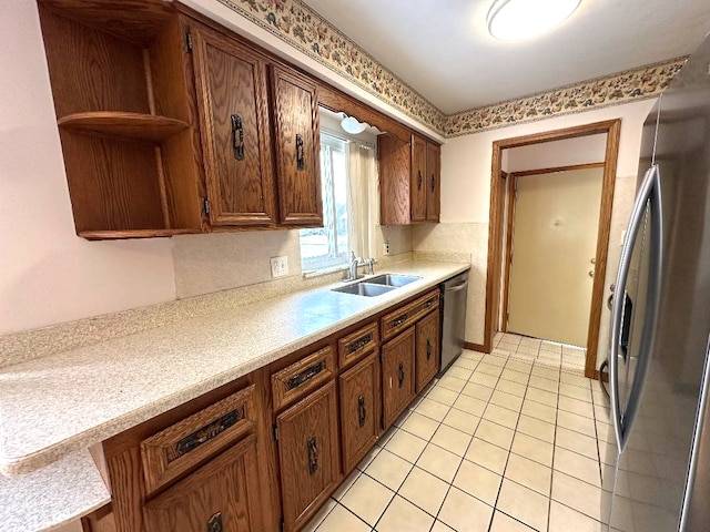 kitchen featuring a sink, light countertops, light tile patterned floors, stainless steel appliances, and open shelves