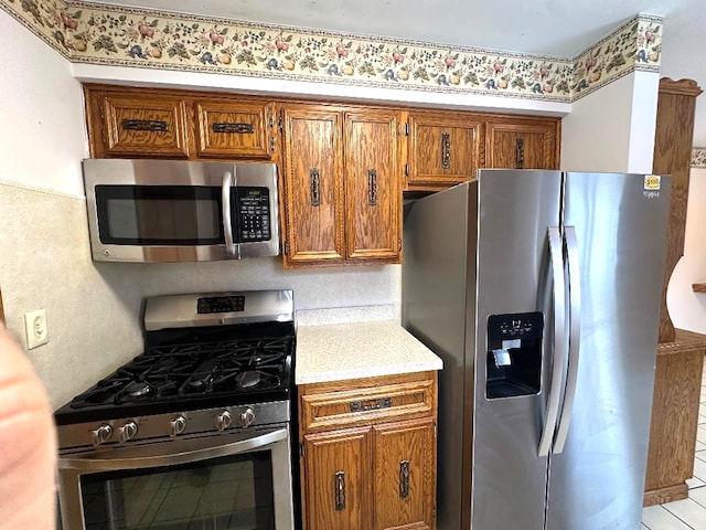 kitchen featuring brown cabinetry and stainless steel appliances