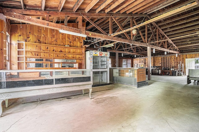 interior space with lofted ceiling and concrete floors