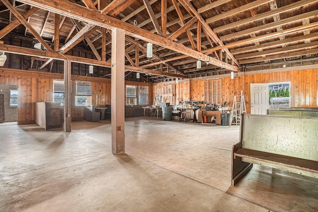 miscellaneous room with lofted ceiling, a healthy amount of sunlight, and concrete floors