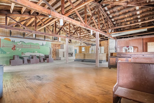 misc room featuring wood-type flooring and vaulted ceiling