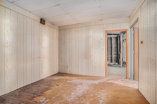 spare room featuring wood walls