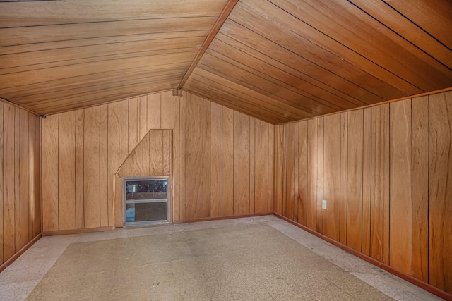 bonus room with wood ceiling, lofted ceiling, and wooden walls