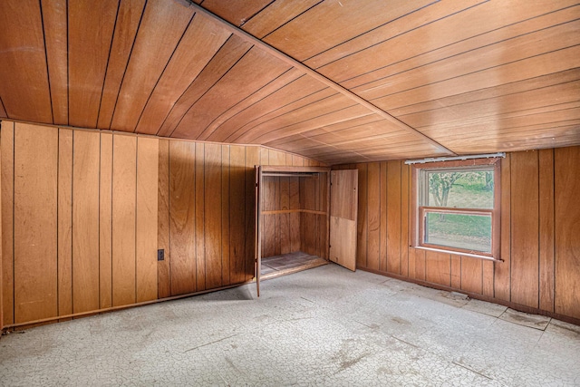 bonus room featuring wood walls, lofted ceiling, and wooden ceiling