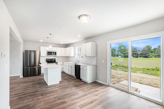 730 Natalia Dr, Davison, MI 48423 - kitchen with appliances with stainless steel finishes, tasteful backsplash, light countertops, plenty of natural light, and recessed lighting