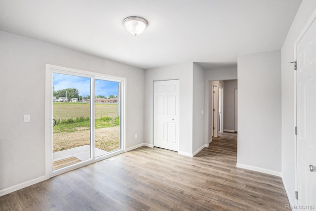 730 Natalia Dr, Davison, MI 48423 - unfurnished bedroom with wood finished floors and access to exterior