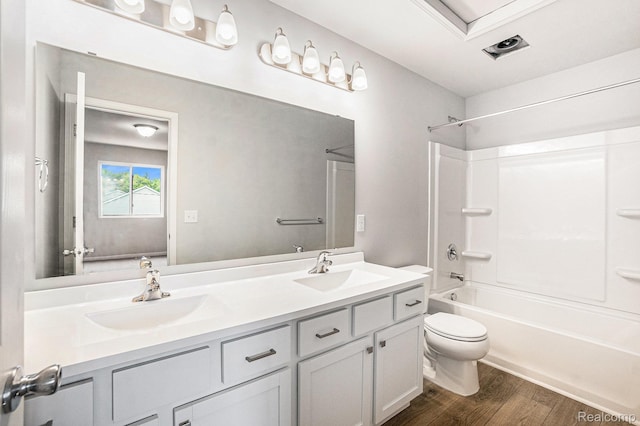 730 Natalia Dr, Davison, MI 48423 - bathroom featuring double vanity, bathing tub / shower combination, and wood finished floors