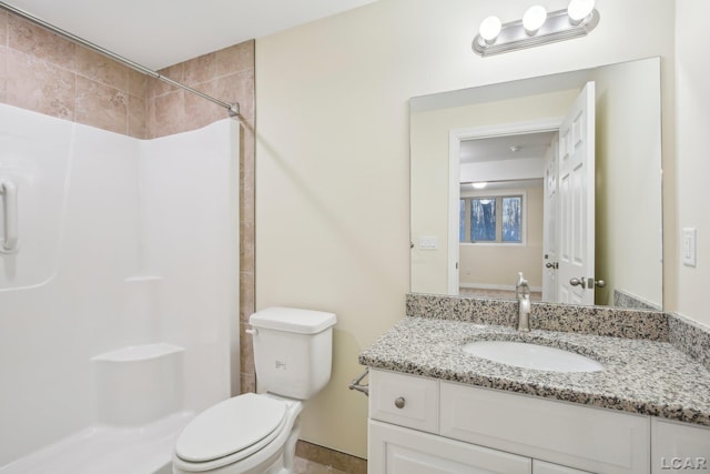 bathroom with walk in shower, vanity, and toilet