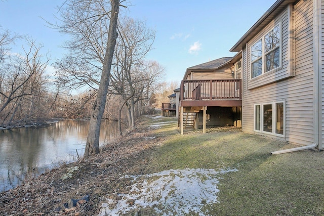 view of yard featuring a deck with water view