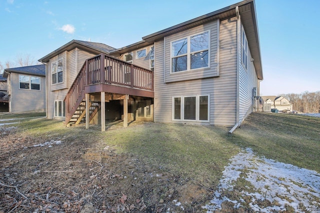 back of property with a wooden deck and a yard