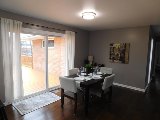 dining room with dark hardwood / wood-style flooring