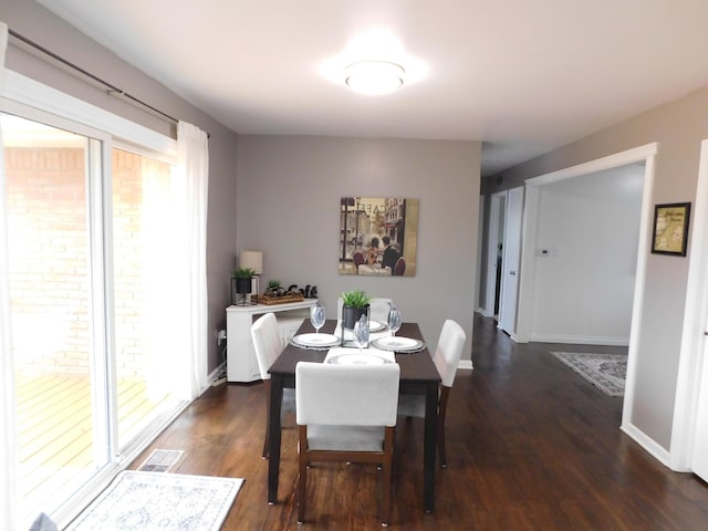 dining space with dark hardwood / wood-style floors