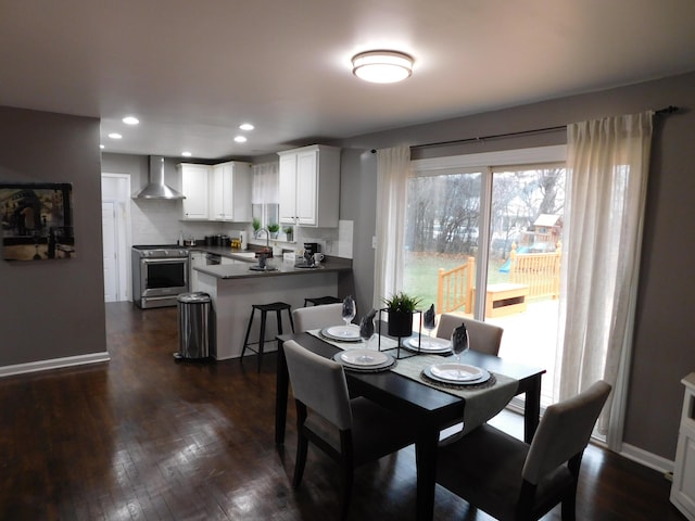 dining room with sink and dark wood-type flooring