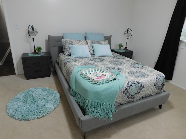 bedroom featuring light colored carpet