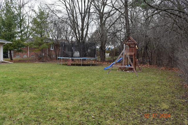 view of yard with a playground and a trampoline